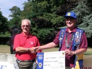 Cheque presentation to Devon Air Ambulance, by Sidmouth Lions President Ian Skinner at the July 2010 Duck race